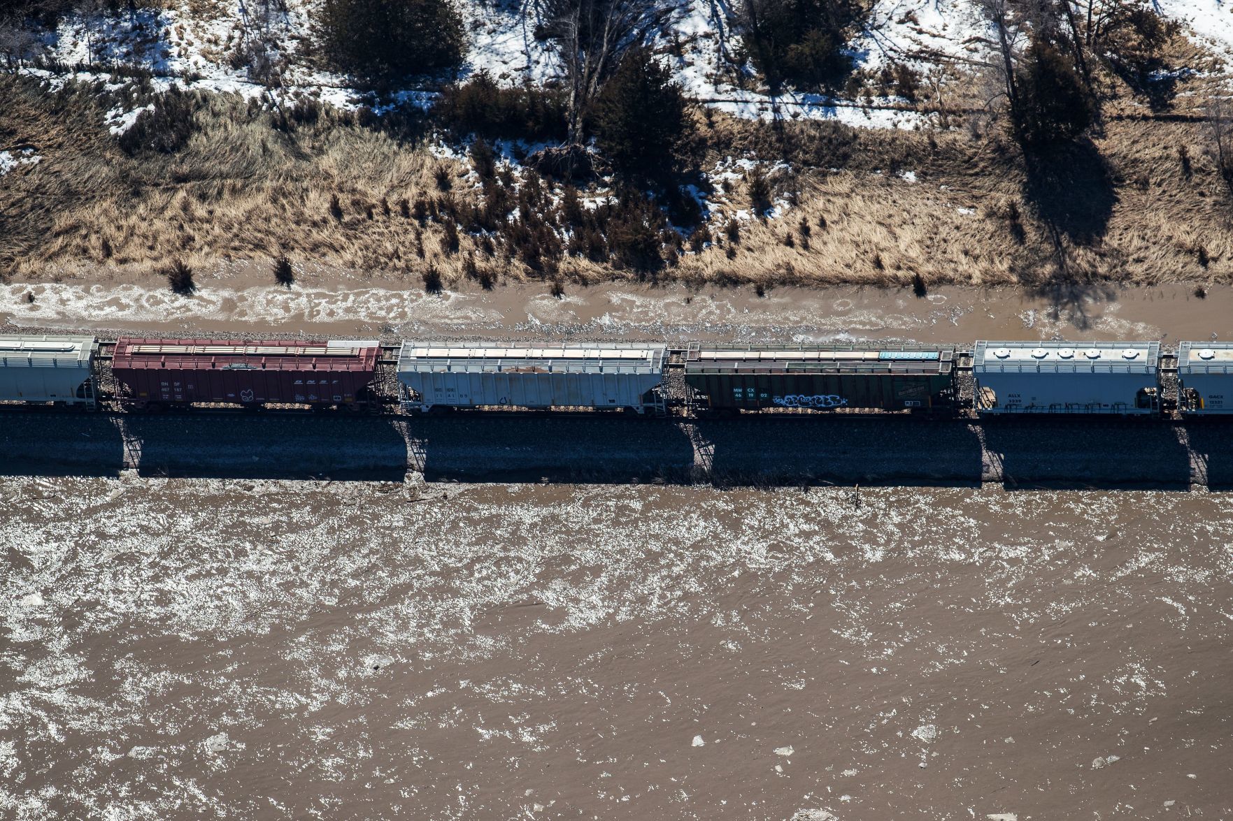 A train is stopped on flooded tracks next to the Platte River near Cedar Creek, Nebraska, on Friday.